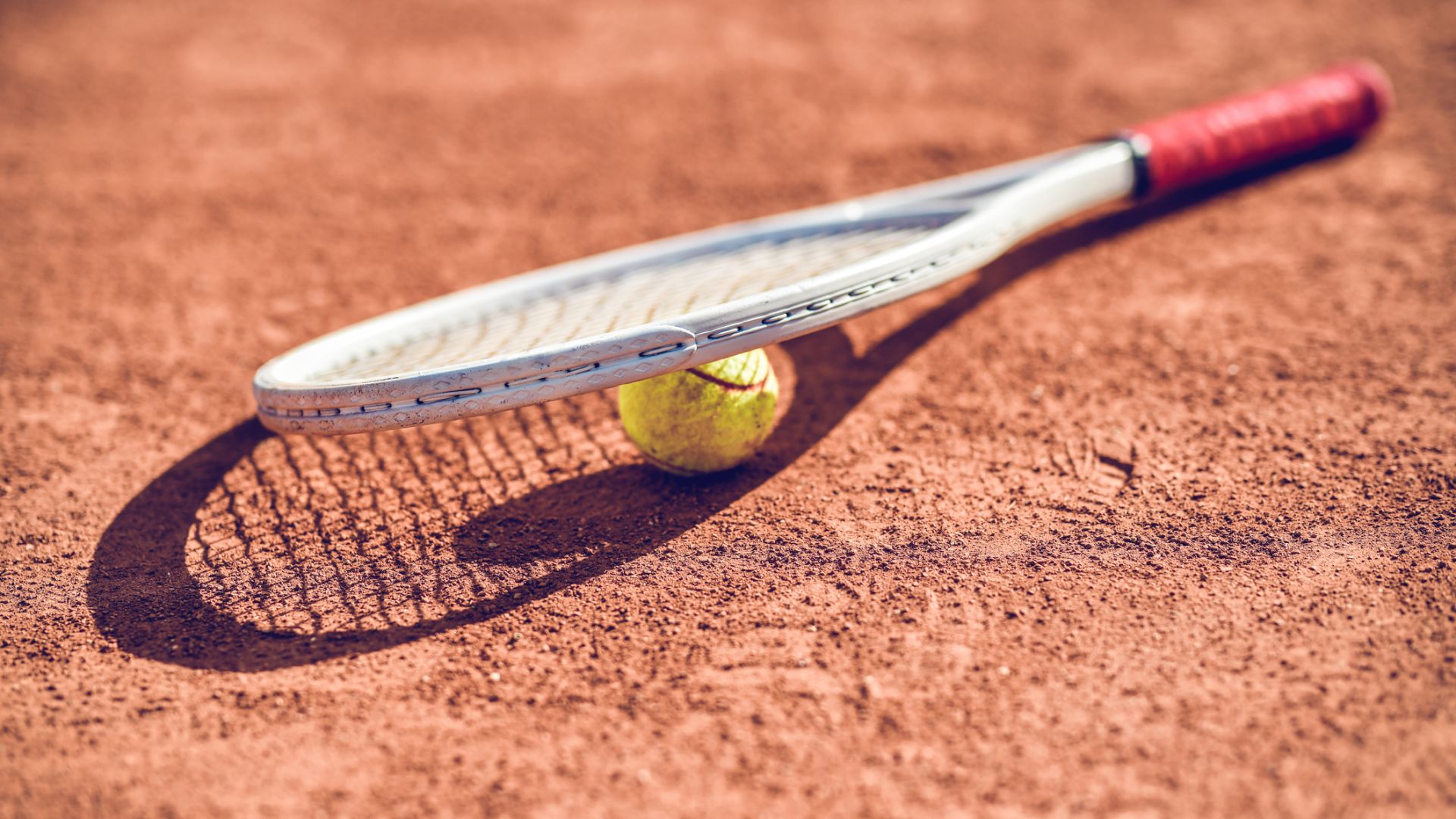 A Close Up Of A Tennis Ball and racquet