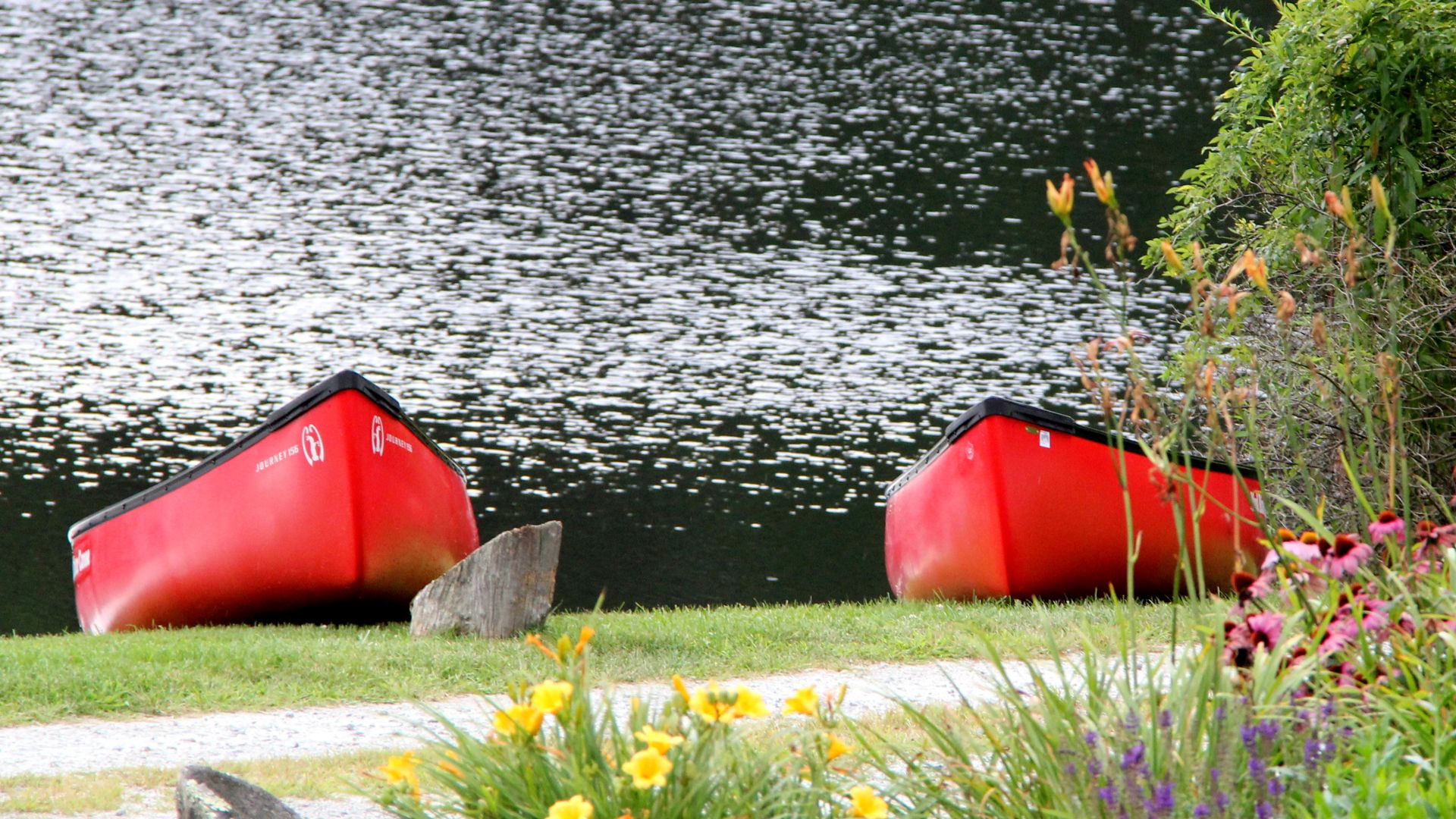 A Red And Yellow Boat Sitting In The Grass
