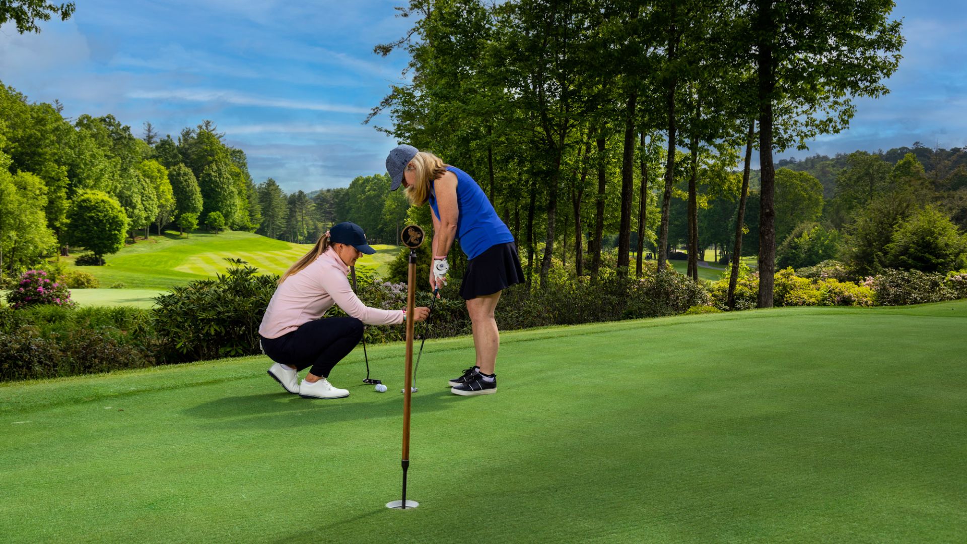 A Couple Of Women Playing Golf